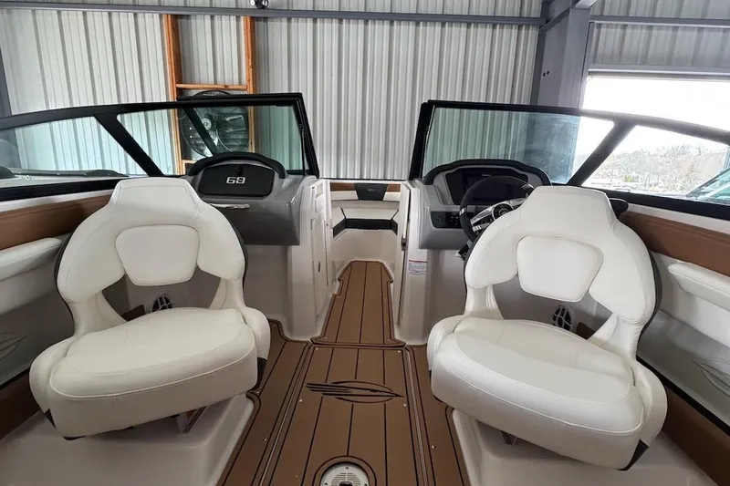 Slide: The Image of Interior of 2025 Chaparral 21 SSi OB boat with white seating and modern dashboard. - 11