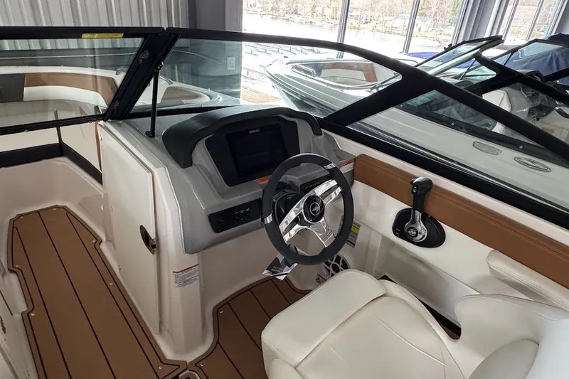 Slide: The Image of Interior view of 2025 Chaparral 21 SSi OB boat cockpit with steering wheel. - 13