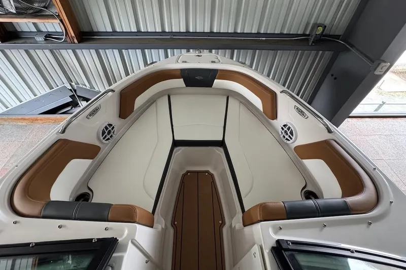 Slide: The Image of 2025 Chaparral 21 SSi OB boat interior with brown and white seating. - 14