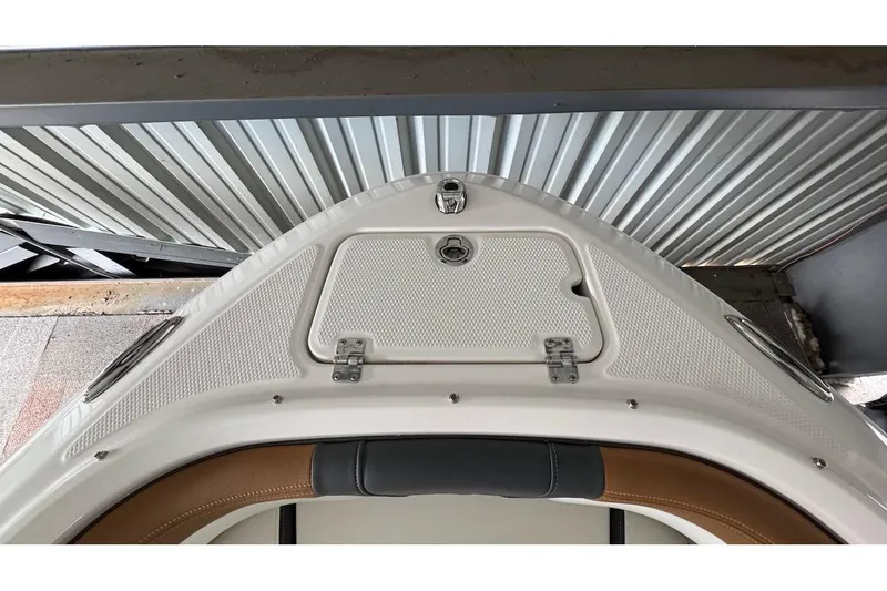 Slide: The Image of 2025 Chaparral 21 SSi OB boat bow with storage compartment and sleek design. - 16