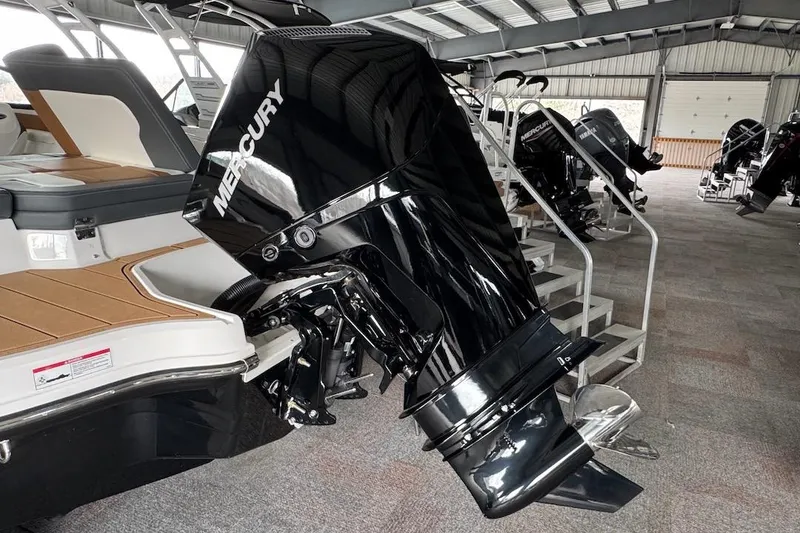 Slide: The Image of 2025 Chaparral 21 SSi OB with Mercury outboard engine in showroom setting. - 20