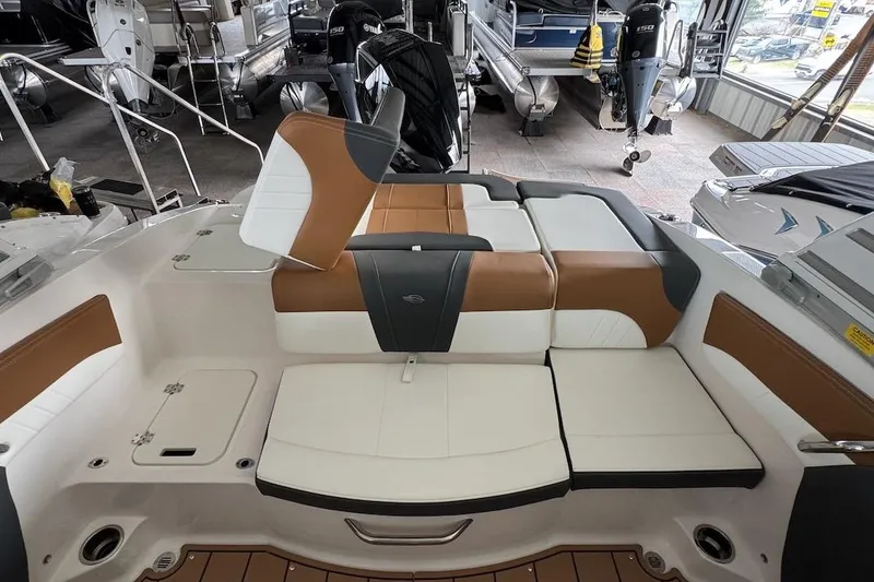 Slide: The Image of 2025 Chaparral 21 SSi OB boat interior with stylish brown and white seating. - 9