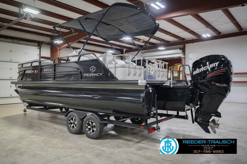 Slide: The Image of 2017 Bennington 220 LE3 pontoon boat with Mercury outboard motor in a showroom. - 10