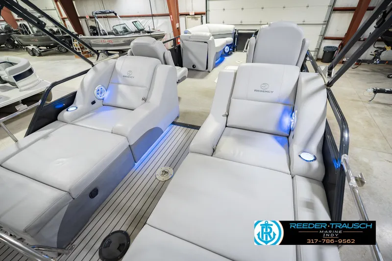 Slide: The Image of 2017 Bennington 220 LE3 pontoon boat with luxurious seating and ambient lighting in showroom. - 14
