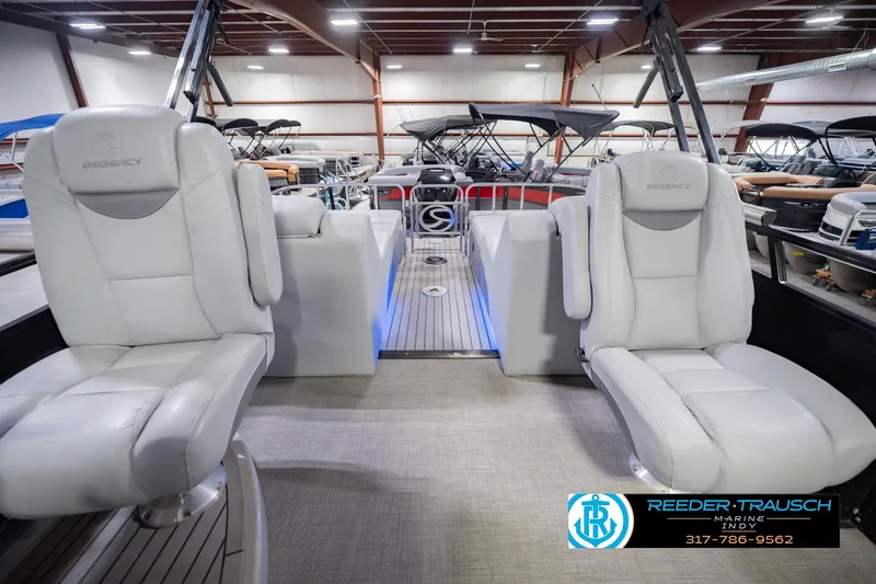 Slide: The Image of Interior of a 2017 Bennington 220 LE3 pontoon boat with plush seating in a showroom. - 17