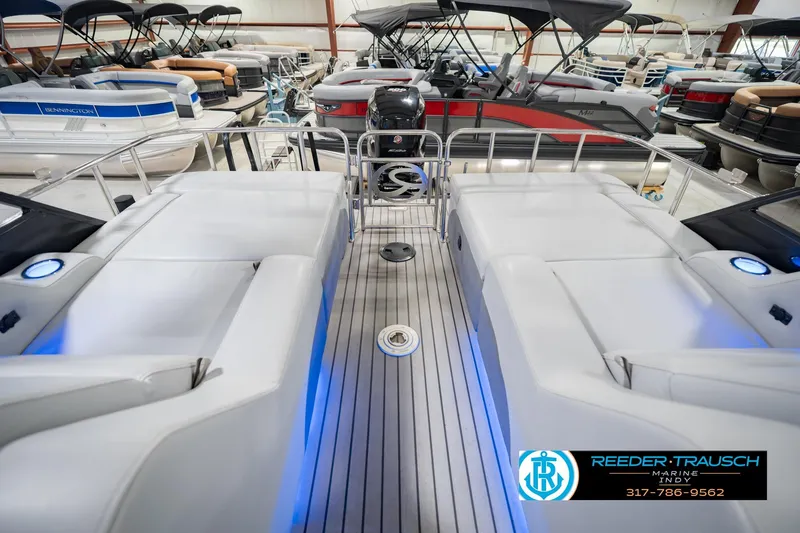 Slide: The Image of 2017 Bennington 220 LE3 pontoon boat interior with white seating and blue accent lighting. - 18