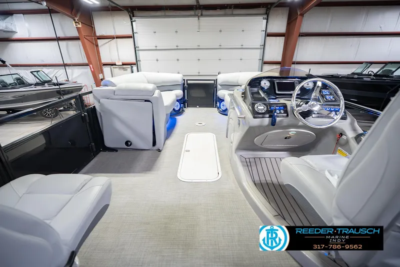 Slide: The Image of Interior of a 2017 Bennington 220 LE3 pontoon boat with modern dashboard and seating. - 20