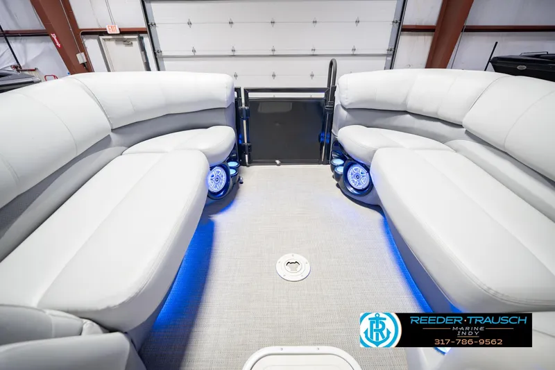 Slide: The Image of Interior of a 2017 Bennington 220 LE3 pontoon boat with plush seating and blue LED lighting. - 21