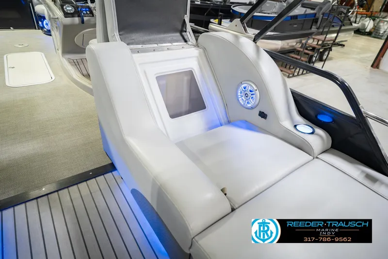Slide: The Image of 2017 Bennington 220 LE3 boat interior with white seating and blue LED lighting. - 28