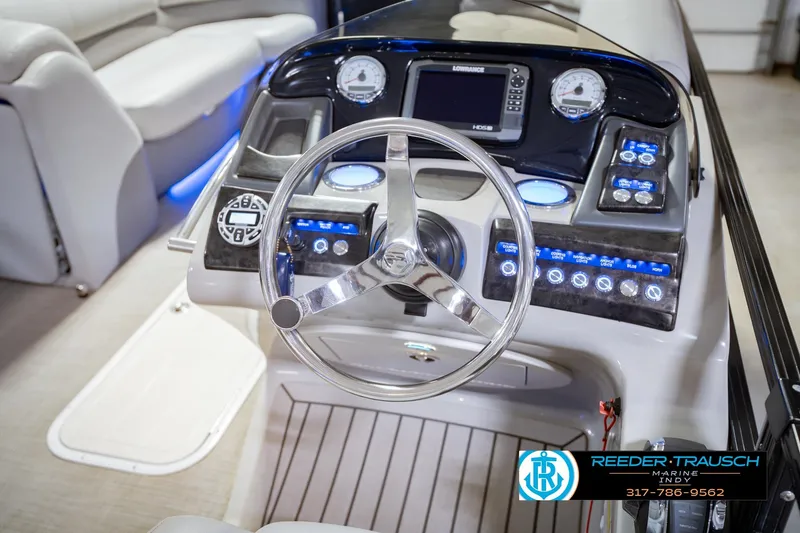 Slide: The Image of Steering console of a 2017 Bennington 220 LE3 pontoon boat with modern controls. - 29