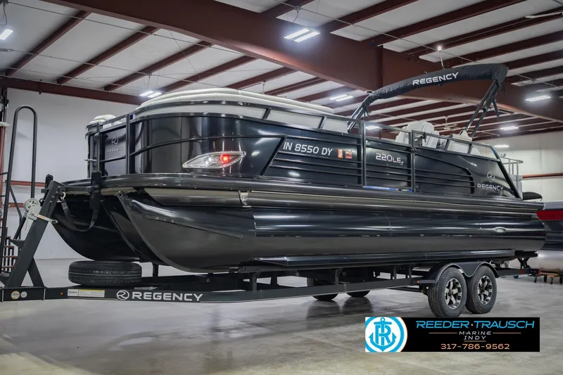 Slide: The Image of 2017 Bennington 220 LE3 pontoon boat on trailer in indoor showroom. - 3