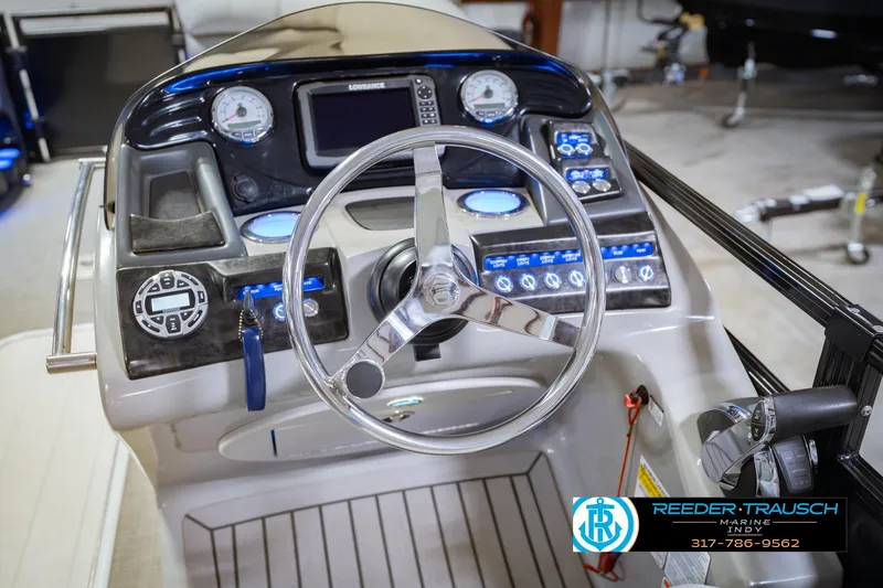 Slide: The Image of 2017 Bennington 220 LE3 boat dashboard with steering wheel and control panel. - 30