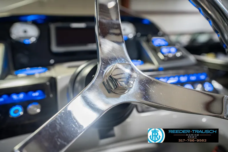 Slide: The Image of Steering wheel of a 2017 Bennington 220 LE3 boat with illuminated dashboard controls. - 31