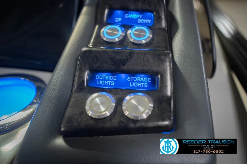 Slide: The Image of Control panel of a 2017 Bennington 220 LE3 boat with illuminated light switches. - 37