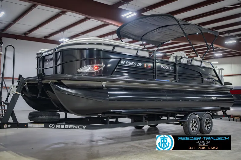 Slide: The Image of 2017 Bennington 220 LE3 pontoon boat on trailer in indoor showroom. - 4