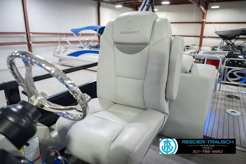 Slide: The Image of Captain's chair on a 2017 Bennington 220 LE3 pontoon boat in showroom setting. - 40