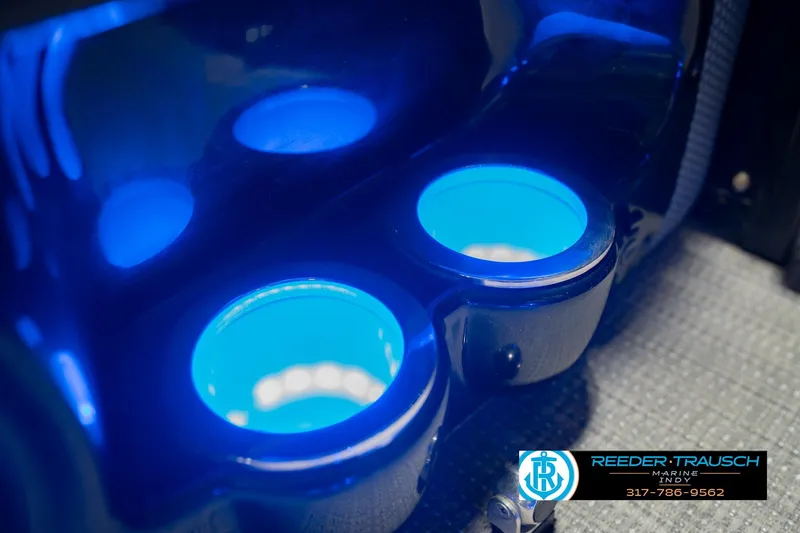 Slide: The Image of Illuminated cup holders on a 2017 Bennington 220 LE3 boat, featuring blue LED lighting. - 47