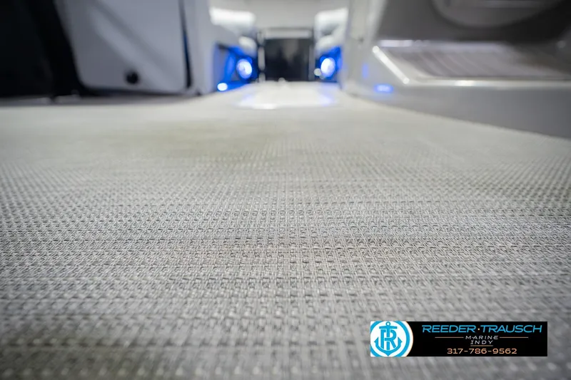 Slide: The Image of Interior flooring of a 2017 Bennington 220 LE3 boat with blue LED lighting. - 48