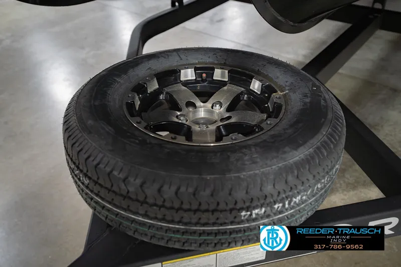 Slide: The Image of 2017 Bennington 220 LE3 trailer tire on display at Reeder Trausch Marine. - 56