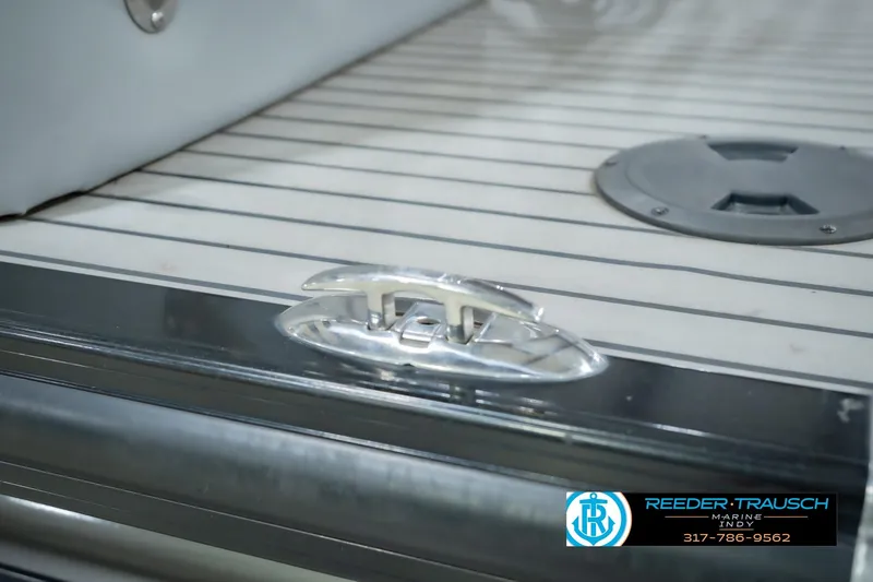 Slide: The Image of 2017 Bennington 220 LE3 boat deck with cleat and hatch, Reeder Trausch Marine logo visible. - 61