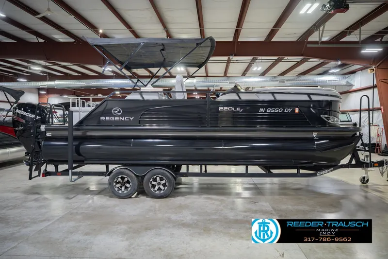 Slide: The Image of 2017 Bennington 220 LE3 pontoon boat in indoor showroom on trailer. - 7