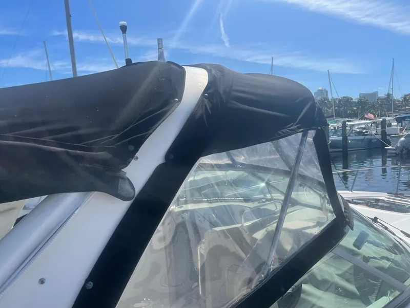 Slide: The Image of 2011 Sea Ray Sundancer 280 with black canopy in marina. - 10