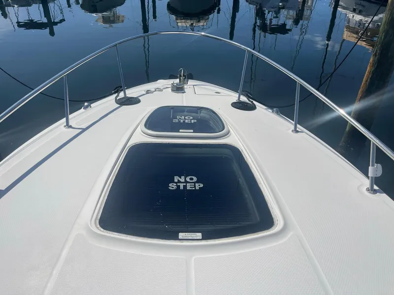 Slide: The Image of Foredeck of 2011 Sea Ray Sundancer 280 with "No Step" warning. - 2