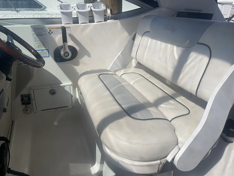 Slide: The Image of Interior of a 2011 Sea Ray Sundancer 280 boat with white seating. - 25