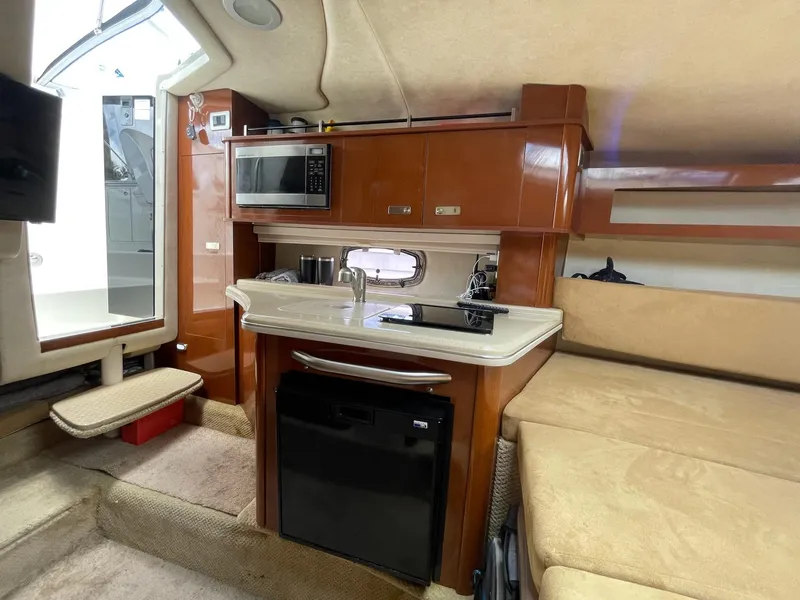Slide: The Image of Interior of 2011 Sea Ray Sundancer 280 yacht with kitchenette and seating area. - 39