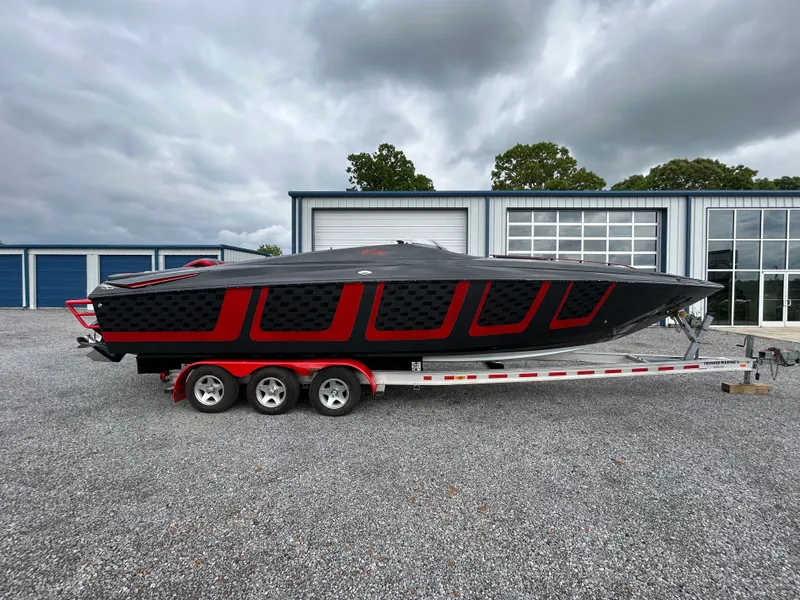 The Image of 2006 Baja 30 Outlaw boat on trailer in front of warehouse. - 0