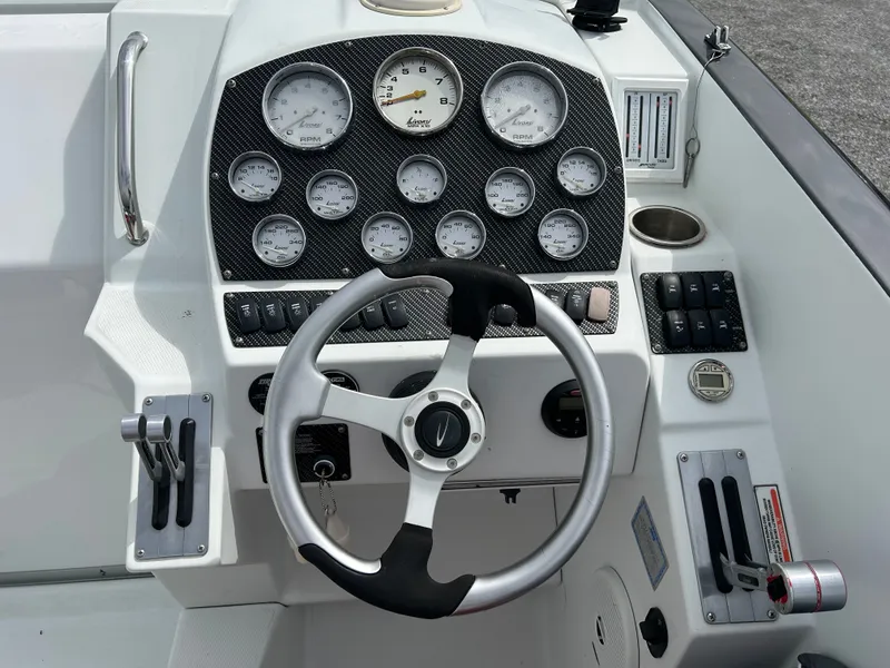 Slide: The Image of 2006 Baja 30 Outlaw boat dashboard with steering wheel and gauges. - 11