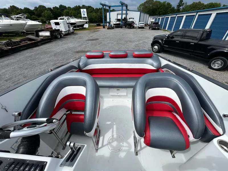 Slide: The Image of Interior of a 2006 Baja 30 Outlaw boat with red and gray seating. - 13