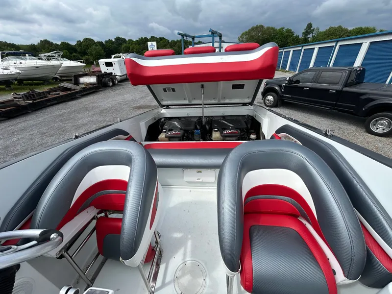 Slide: The Image of 2006 Baja 30 Outlaw boat with open engine compartment and red seats. - 14