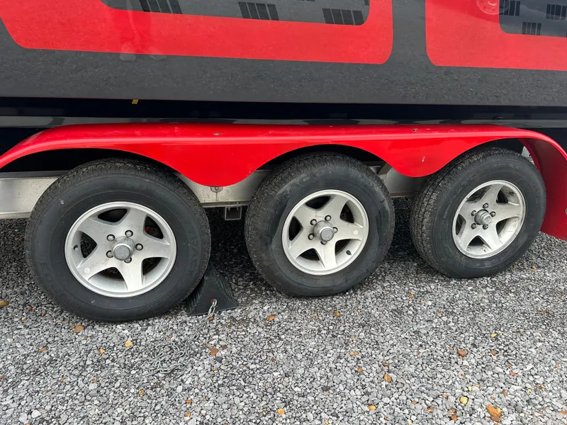 Slide: The Image of 2006 Baja 30 Outlaw trailer with three wheels on gravel. - 17