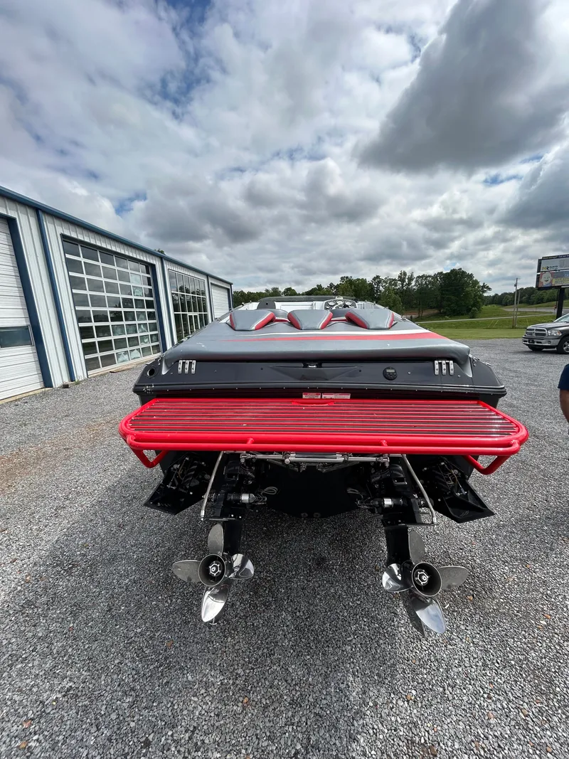 Slide: The Image of Rear view of a 2006 Baja 30 Outlaw boat with red accents. - 2