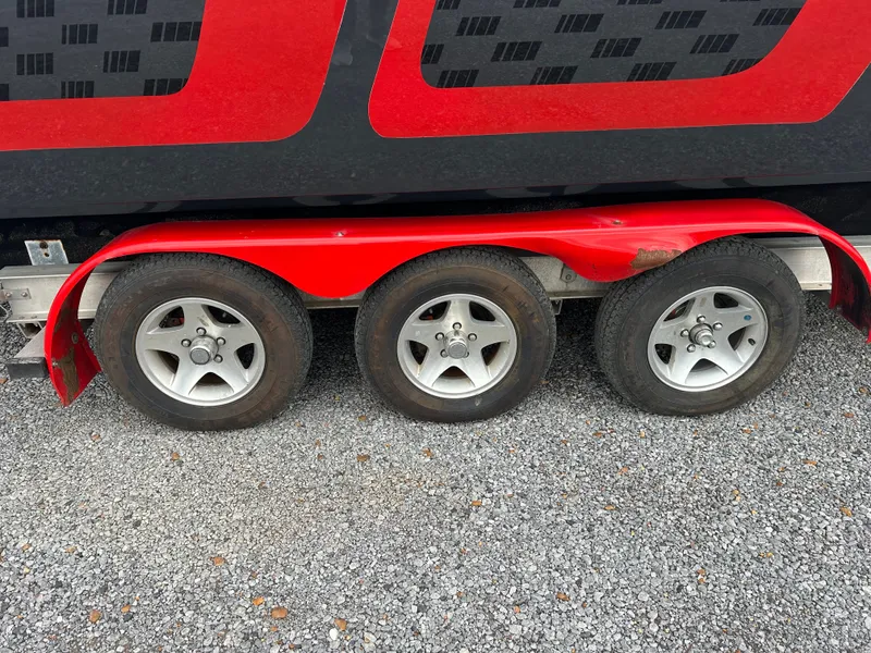 Slide: The Image of 2006 Baja 30 Outlaw trailer with three wheels on gravel. - 20