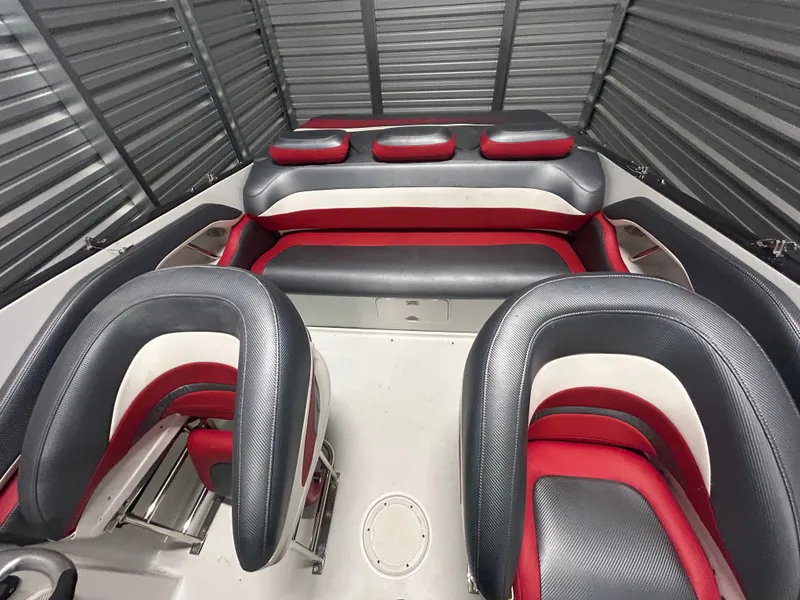 Slide: The Image of Interior of a 2006 Baja 30 Outlaw boat with red and gray seating. - 24