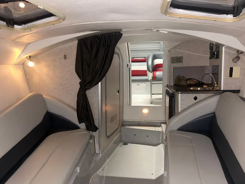 Slide: The Image of Interior of a 2006 Baja 30 Outlaw boat with seating and kitchenette. - 27