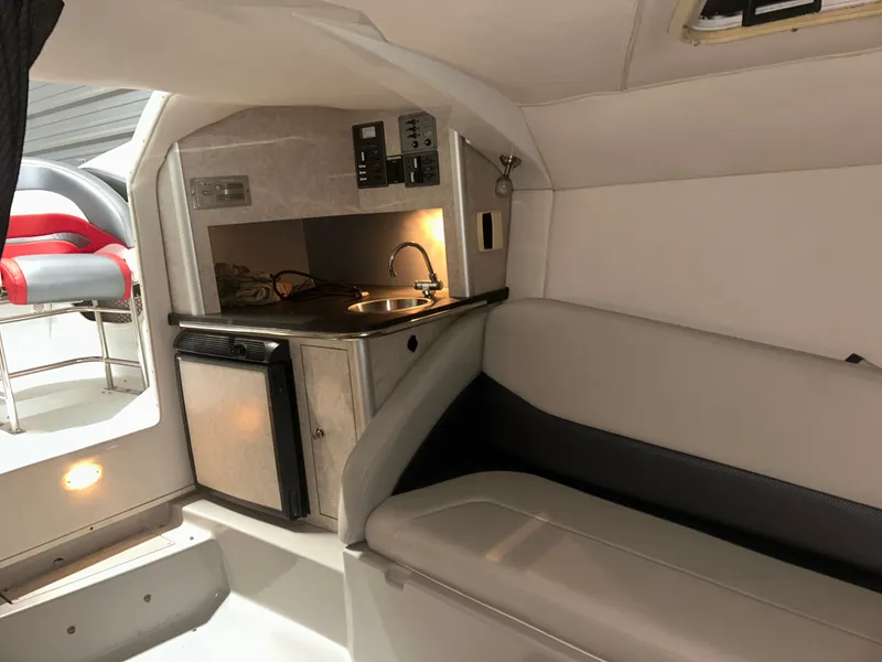 Slide: The Image of Interior of a 2006 Baja 30 Outlaw with kitchenette and seating area. - 29