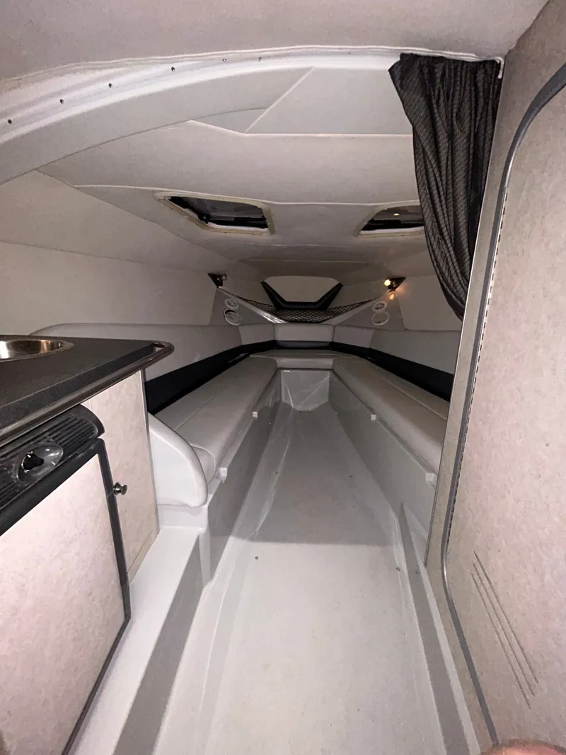 Slide: The Image of Interior of a 2006 Baja 30 Outlaw boat, modern and spacious. - 31