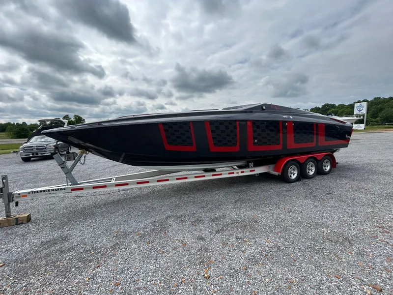 Slide: The Image of 2006 Baja 30 Outlaw boat on trailer, cloudy sky. - 32