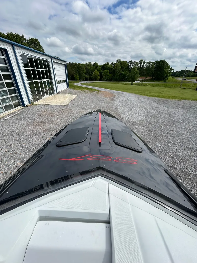 Slide: The Image of 2006 Baja 30 Outlaw boat near garage and lawn. - 8