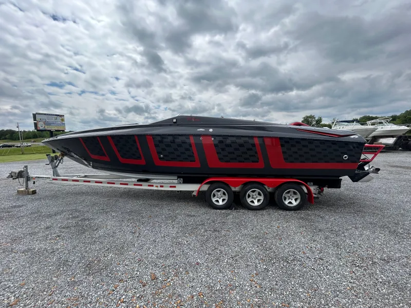 Slide: The Image of 2006 Baja 30 Outlaw boat on trailer under cloudy sky. - 4