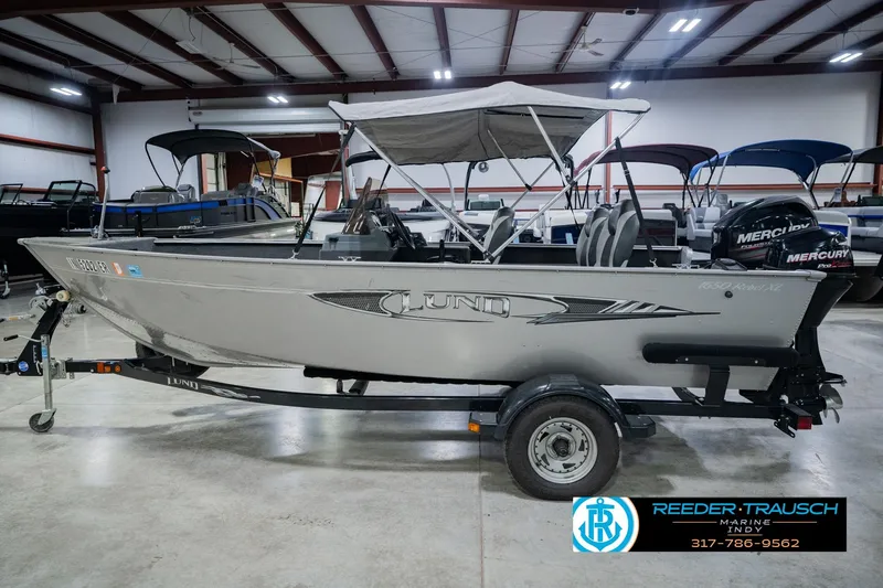 Slide: The Image of 2013 Lund 1650 Rebel XL Sport boat on trailer in indoor showroom. - 11