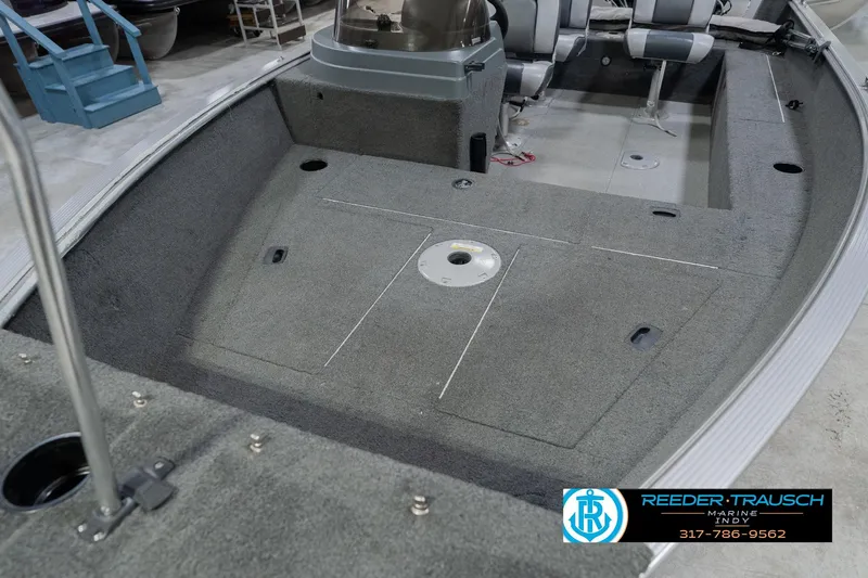Slide: The Image of 2013 Lund 1650 Rebel XL Sport boat interior with gray carpet and seating. - 12
