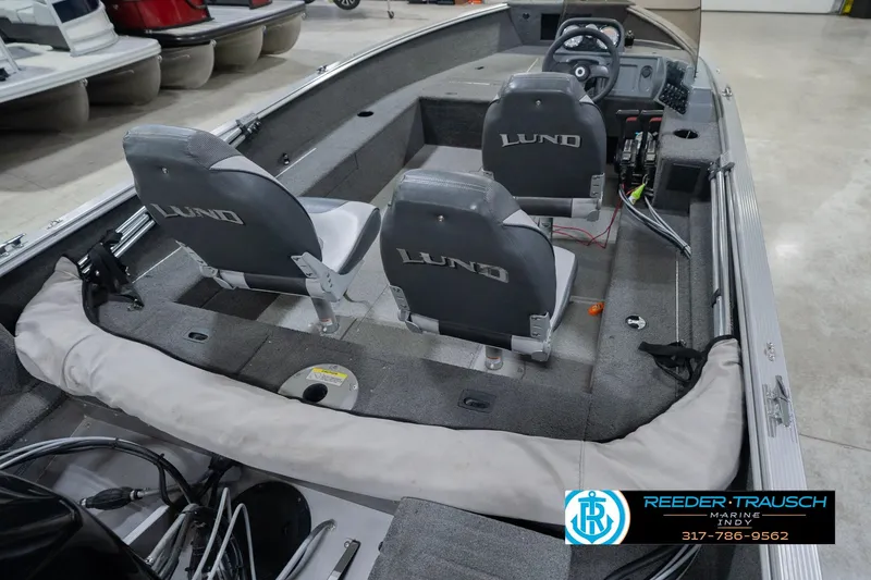 Slide: The Image of 2013 Lund 1650 Rebel XL Sport boat interior with dual seats and steering console. - 14