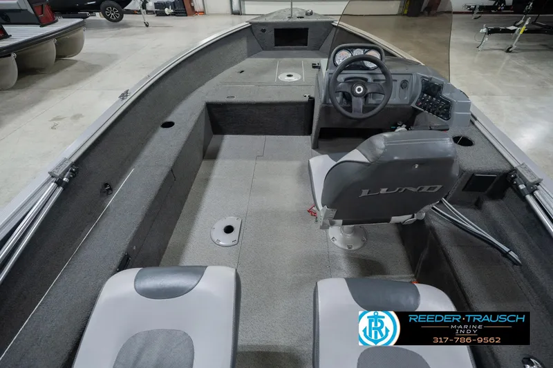 Slide: The Image of 2013 Lund 1650 Rebel XL Sport boat interior with steering console and seating. - 16