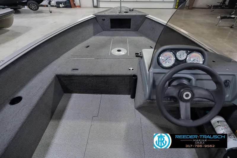 Slide: The Image of 2013 Lund 1650 Rebel XL Sport boat interior with steering wheel and dashboard gauges. - 17