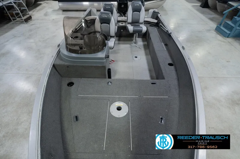 Slide: The Image of 2013 Lund 1650 Rebel XL Sport boat interior with seating and steering console. - 19