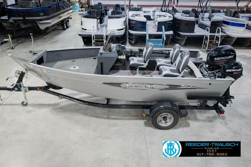 The Image of 2013 Lund 1650 Rebel XL Sport fishing boat on trailer in showroom. - 2